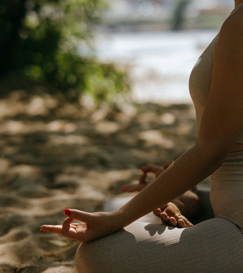 Woman performing a gentle, low-impact exercise in a calm environment.